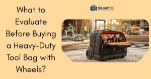 A heavy-duty black rolling tool bag with large all-terrain wheels, open wide-mouth top showing an organized orange interior filled with wrenches, screwdrivers and power tools, sitting on a construction site with workers and equipment in the background — ToolCarryPro